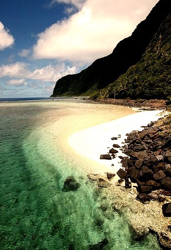 Turquoise water, green mountains and white sand in American Samoa